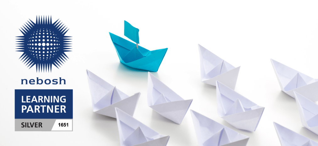 Image of white paper boats led by a single blue boat.